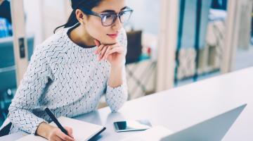 Woman works at laptop