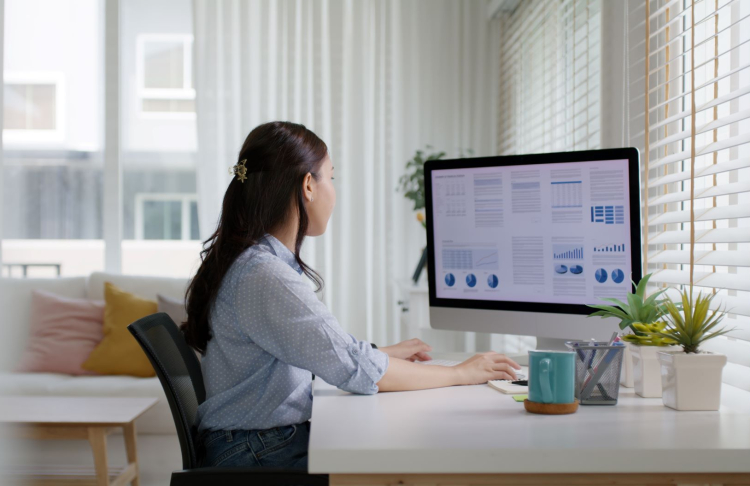 Woman working at a desktop computer.