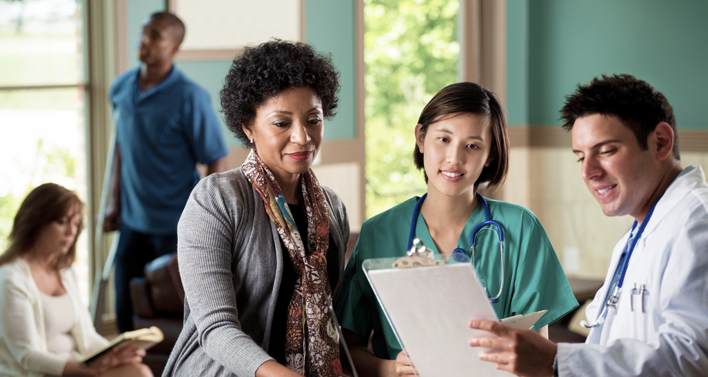 doctor nurse and patient looking over information