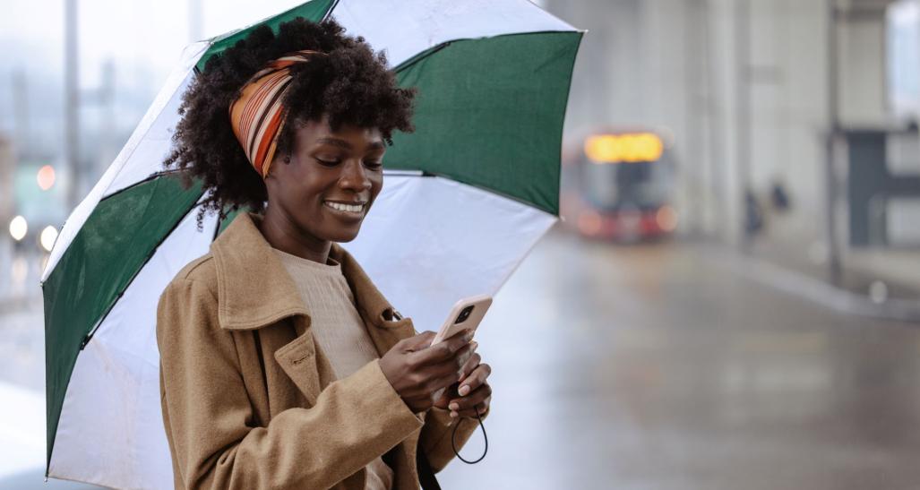 Woman on her phone in the rain.