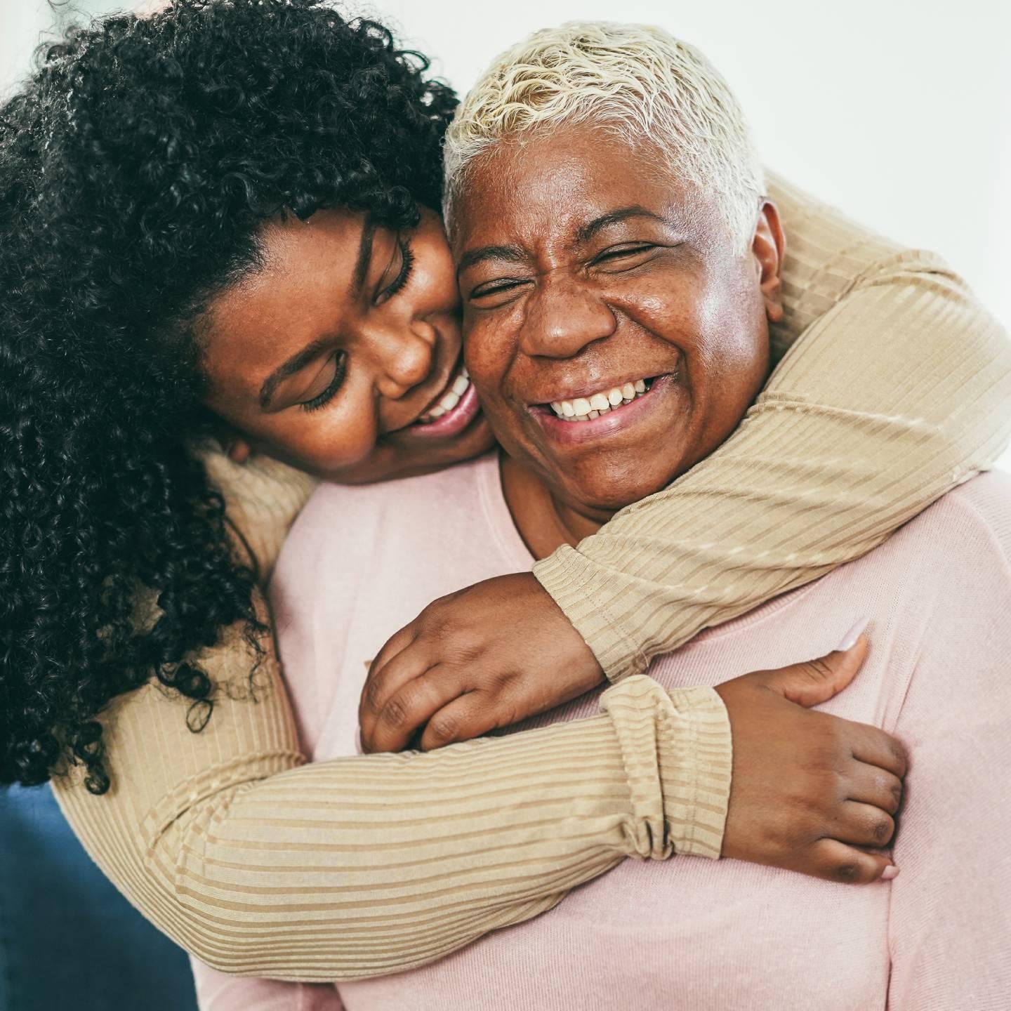 A mother and daughter hugging.