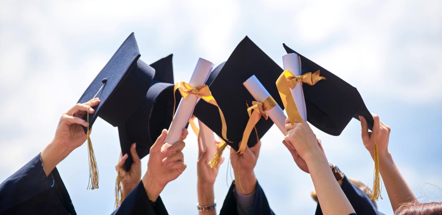 Graduates tipping their caps.