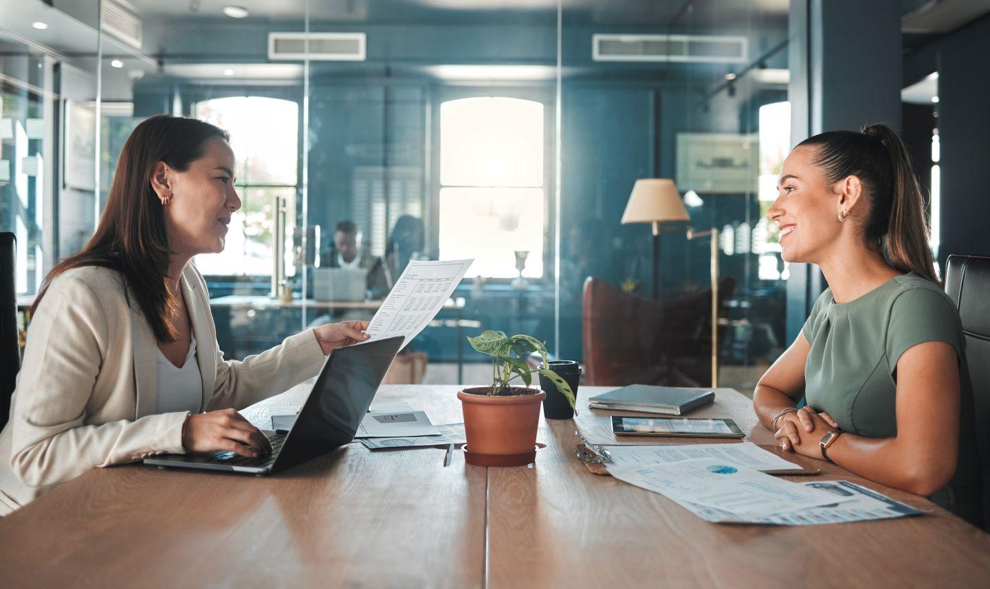 Two individuals meeting at work.