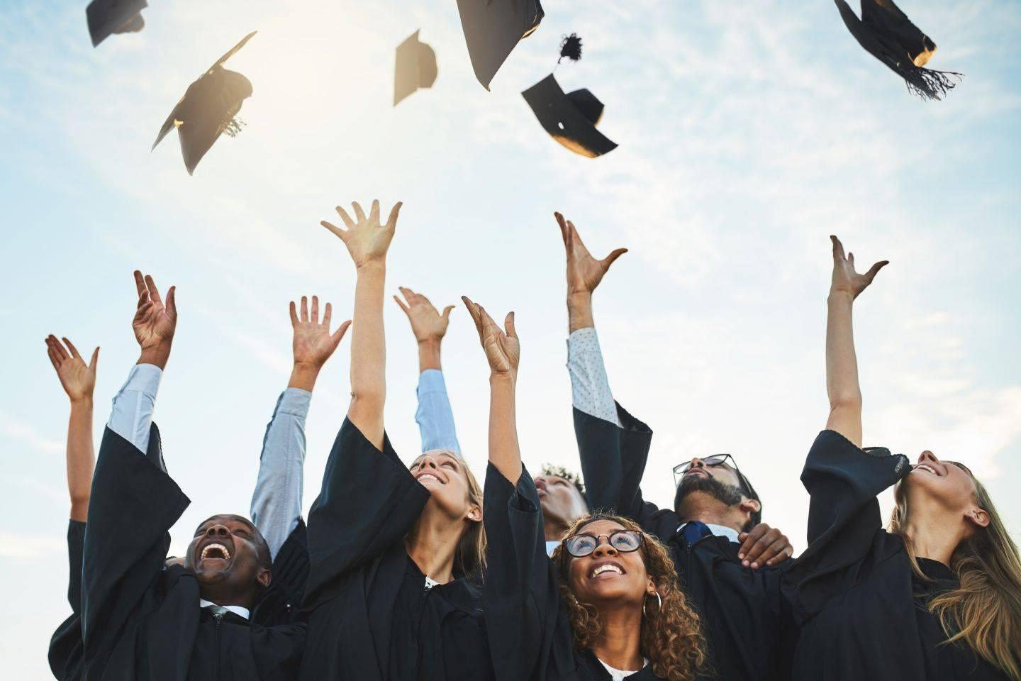 Graduates tipping their caps.