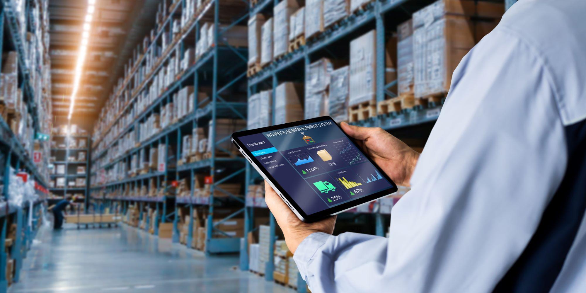 A retail employee using technology in a warehouse.