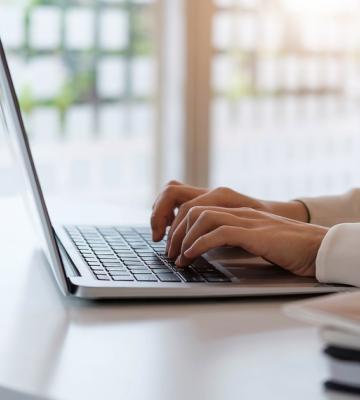 hands typing on a laptop