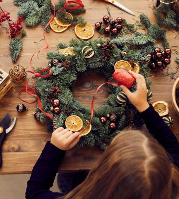 Woman making a holiday wreath.