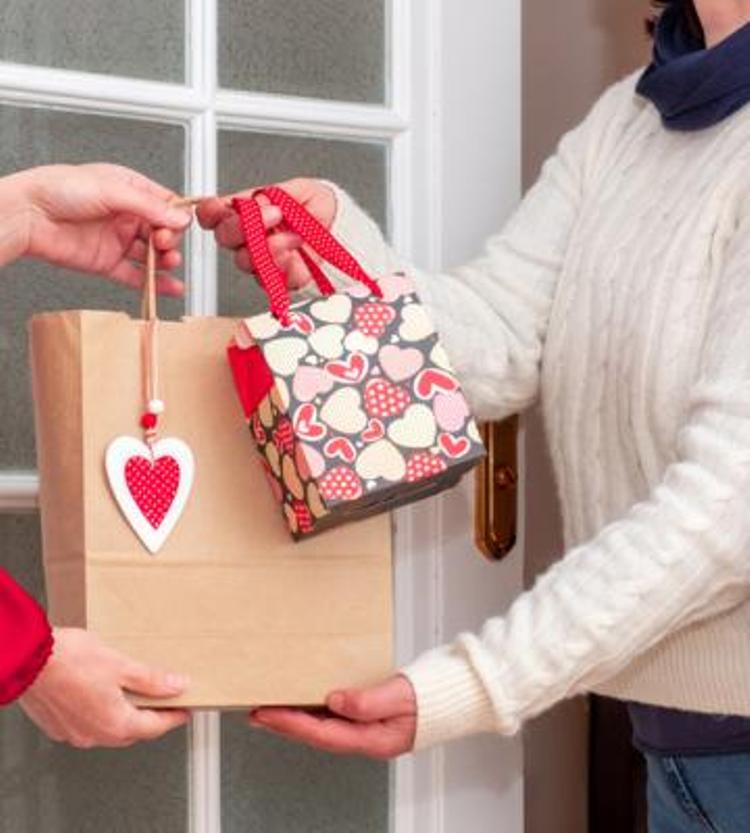 Valentine's Day gifts being handed to someone.