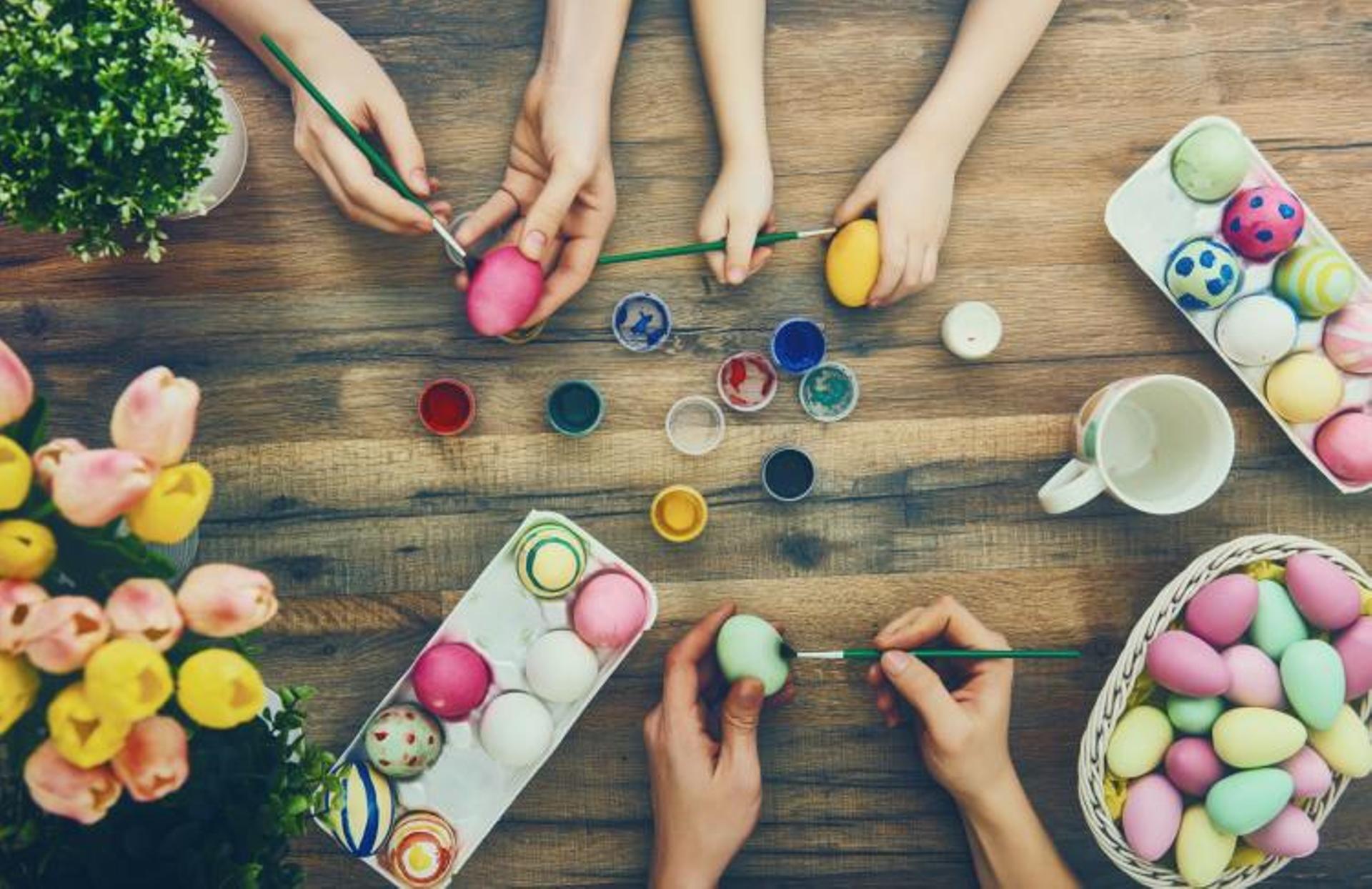 Photo of hands painting easter eggs