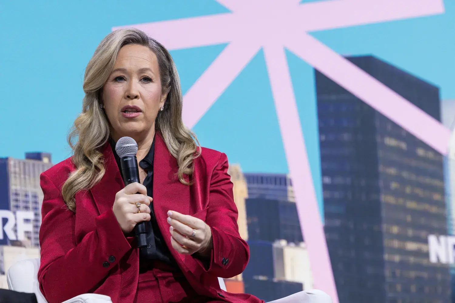 Seated on the NRF'26 stage, PacSun's CEO Brieane Olson speaks to the audience.