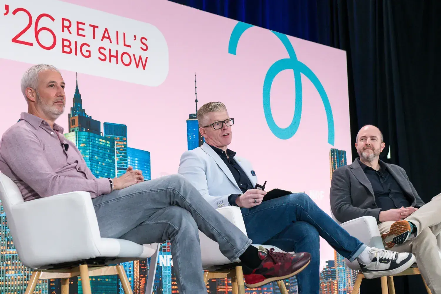 From left to right: Ariel Haroush (CEO and founder of retail experience innovation agency Outform), Michael Budzisz (vice president of in-store creative and innovation at Dick’s Sporting Goods), and David Littlefield (managing director EMEA at Outform) on stage at NRF'26.