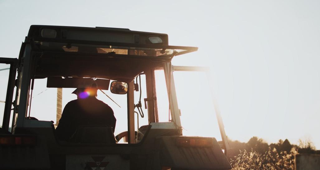 farm worker driving heavy equipment