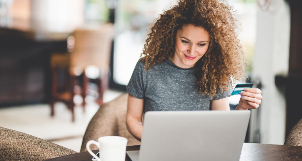 Woman shops online on a laptop