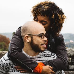 a young couple holds each other outside in the cold