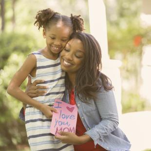 Mother and daughter with Mother's Day card