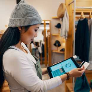 Store clerk runs credit card through tablet 