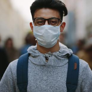 Man wearing a mask in crowd of protesters