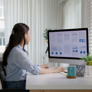 Woman working at a desktop computer.