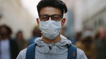 Man wearing a mask in crowd of protesters